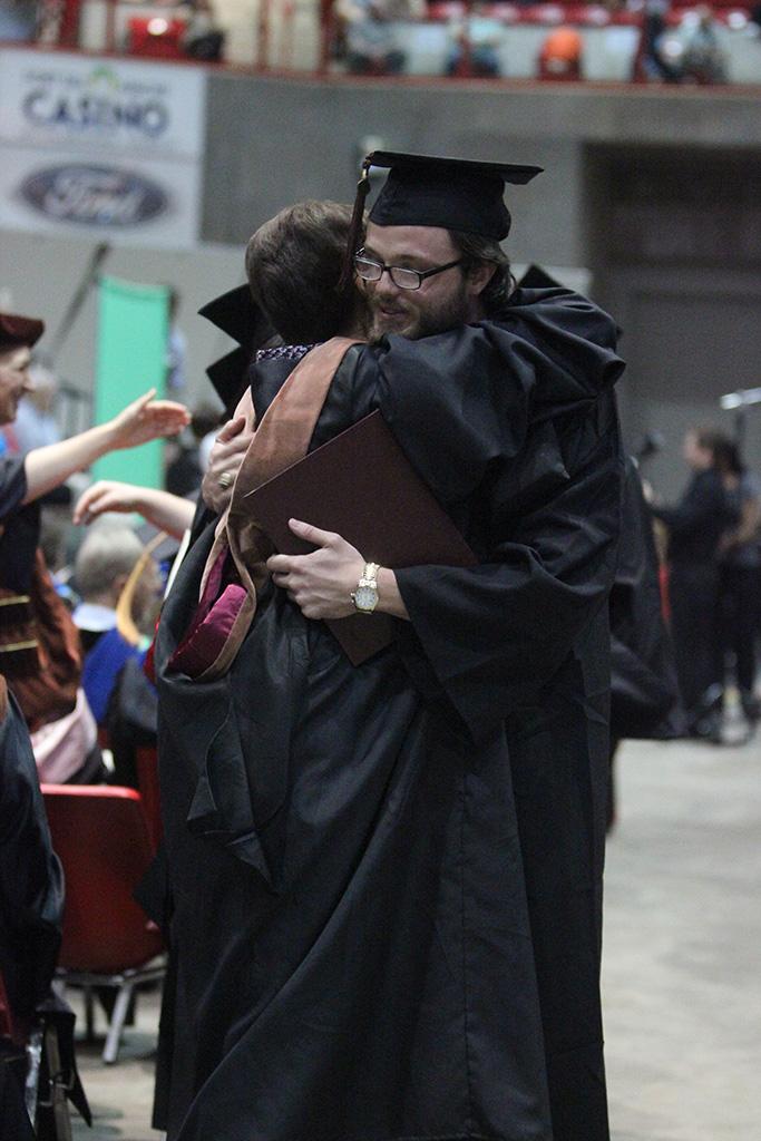 Maxwell Norris, theatre, hugs Laura Jefferson, theater professor, who is now retiring, at the Midwestern State University graduation, May 16, 2015 at the Kay Yeager Coliseum. Photo by Rachel Johnson