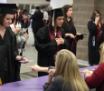 Melanie Sharp, nursing, and Stephanie Rodriguez, general business, check in and receive their name cards at Midwestern State University graduation, May 16, 2015 at the Kay Yeager Coliseum. Photo by Francisco Martinez