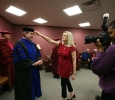 Cindy Ashlock, executive assistant to the President, moves Retiring University President Jesse Rogers' tassle out of his face int he greeen room before the ceremony at Midwestern State University graduation, May 16, 2015 at the Kay Yeager Coliseum. Photo by Rachel Johnson
