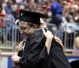 Ethan Metcalf, mass communication, hugs Liz Minden, mass communication, while walking back to his chair. at Midwestern State University graduation, May 16, 2015 at the Kay Yeager Coliseum. Photo by Rachel Johnson