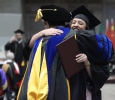 Jim Sernoe, associate professor of mass communication, hugs Kayla Norris at the Midwestern State University graduation, May 16, 2015 at the Kay Yeager Coliseum.