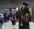 Farrellin Porter, nursing, sends a big wave tothe audience while walking back to her seat after receiving her diploma at Midwestern State University graduation, May 16, 2015 at the Kay Yeager Coliseum. Photo by Rachel Johnson