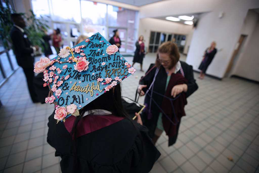 Amber Garcia wore a mortar board decorated "The flower that blooms in adversity is the most rare and beautiful of all." Garcia said was because "I had a lot of struggles and my family helped me through it." Photo by Bradley Wilson
