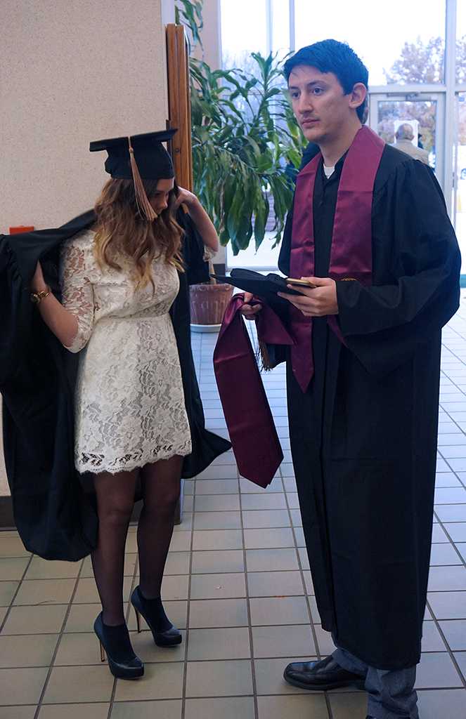 Business majors, Madeline Hoff and Ryan Booker put together their attire for commencement at the Midwestern State University graduation Dec. 17, 2016. Photo by Brendan Wynne