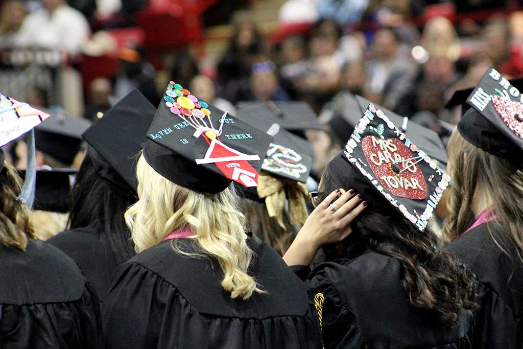 Graduates enjoyed decorating their hats for the second time in the schools history at the Midwestern State University graduation, Fall 2016. Photo by Jeanette Perry.