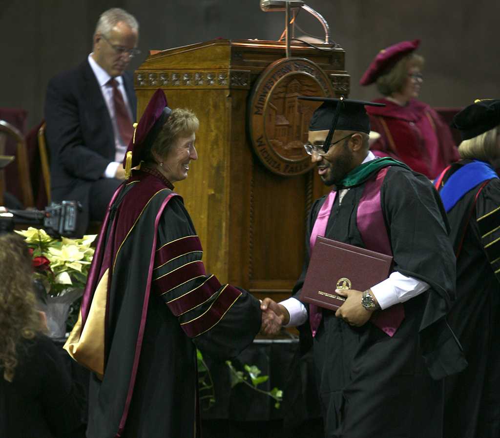 University president Suzanne Shipley shakes the hand of a graduate at Midwestern State University fall graduation Dec. 17, 2016. Photo by Brendan Wynne