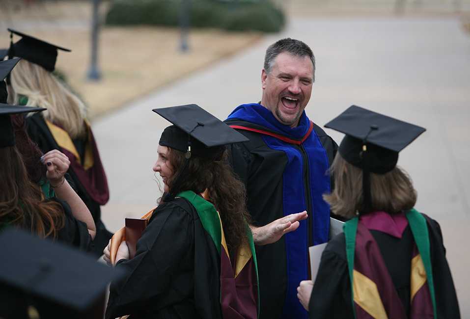 Jeff Killion, radiologic sciences chair, high-fives students after the ceremony at Midwestern State University fall graduation Dec. 17, 2016. Photo by Brendan Wynne