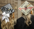 Blaire Untalen and Kari Goen, nursing graduates, show off their hats at the Midwestern State University graduation, Fall 2016. Photo by Jeanette Perry.