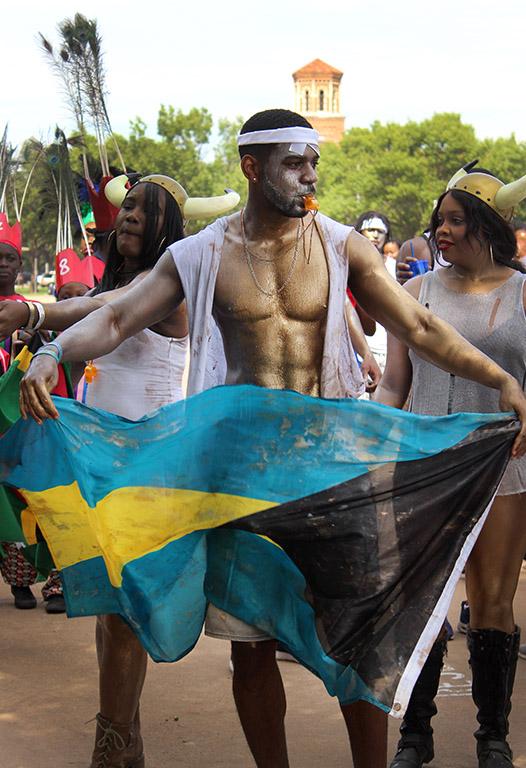 Theo Rolle, mechanical engineer junior, waves the Bahama flag during the Caribfest Parade that looped from Dillard to Jesse Rogers Promenade Sept. 30. Photo by Rachel Johnson