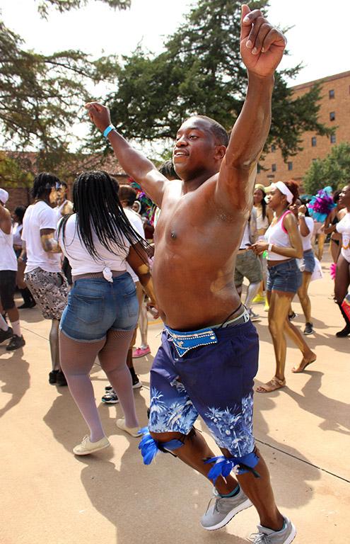 Akeem Shaw, accounting senior, runs through the Caribfest Parade hyping people up by dancing and singing the songs. Photo by Rachel Johnson
