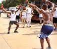 Dave Hughes, accounting senior, and Akeem Shaw, accoutning senior, start to dance together during the Caribfest Parade that looped from Dillard to Jesse Rogers Promenade Sept. 30. Photo by Rachel Johnson