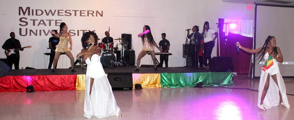 Spice and Ice show off their bright white dresses and glittered back up dancers as they sing No Bad Vibes as their talent for the 2017 Caribfest Soca Show hosted in the Sikes Lake Center. Sept. 29. Photo by Marissa Daley