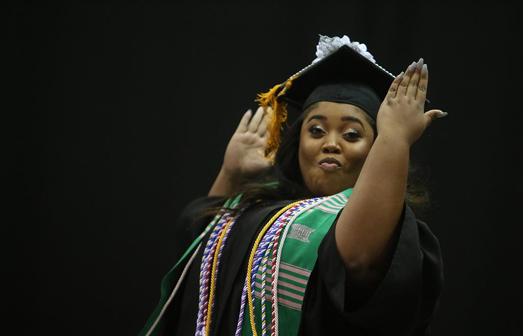 Christina Breedlove jumps across stage at graduation, Dec. 16, 2017. Breedlove received her Bachelor of Science in Nursing. Photo by Bradley Wilson