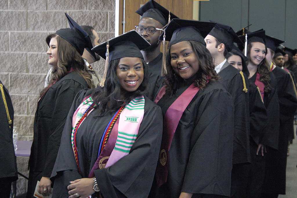 Shayla Owens, BBA graduate, and Alexus Page, BBA graduate, pose while waiting for the the line to move to go to the colliseum at the fall 2017 commencement at the Kay Yeager Colliseum on Sat. Dec. 16, 2017. Photo by Justin Marquart