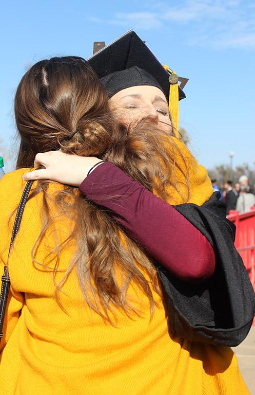 Mallory Rice, psychology, hugs Taylor Lindsay, finance junior, after leaving Kay Yeager Coliseum after the end of Commencement, Dec. 16, 2017. Photo by Rachel Johnson