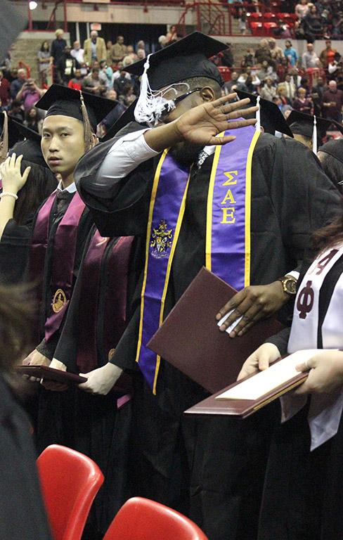 Valentine Atuchukwu, education, does a dab during the alma mater at the end of commencement in Kay Yeager, Sat. Dec. 16, 2017. Photo by Rachel Johnson