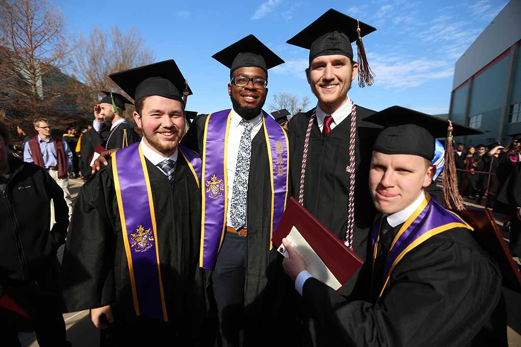 Tyler Browning, Valentine Atuchukwu, Seth Phillips and Mike Privitt at graduation, Dec. 16, 2017. Photo by Bradley Wilson