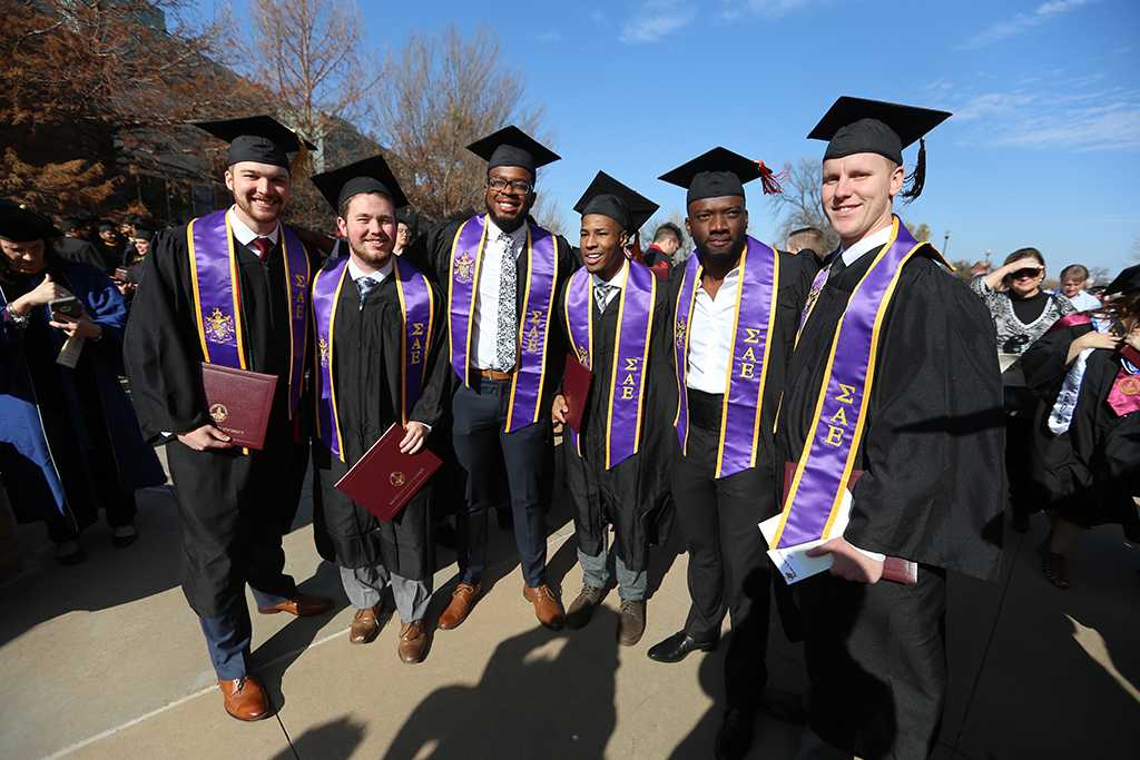 SAE members at graduation, Dec. 16, 2017. "They're lifelong friends, so it's bittersweet. But we'll stay in touch," Michael Privitt, who received his Bachelor of Business Administration degree, said. Photo by Bradley Wilson