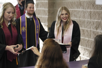 Taylor Amundson, exercise physiology, receives her name card before the MSU commencement ceremony at Kay Yeager Coliseum. Saturday Dec. 16, 2017. Photo by Francisco Martinez