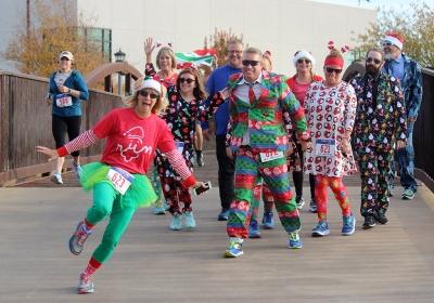 A group of participants in the Fantasy of Lights 5k who dressed up for the best and worst costume contest, which they announced the winners before the race out side the Wichita Falls Museum of Arts, Dec. 2, 2017. Photo by Rachel Johnson