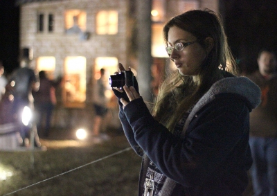 Carina Peterson, radiology sophomore, takes pictures of the different lights and scenes set up at the opening ceremony of MSU-Burns Fantasy of Lights Monday, Nov. 20, 2017. "I was walking around [campus] earlier and I thought it would be really nice to see this and I'm also here to see the Wind Ensemble," Peterson said. Photo by Rachel Johnson
