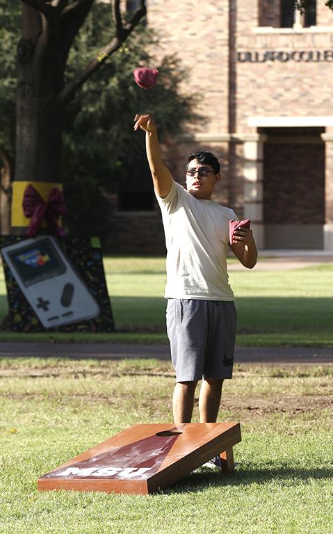 AJ Rubio, mechanical engineering sophomore, tosses a sand bag during a game of cornhole at the quad for field day competitions on Wednesday, Oct 18, 2017. Photo by Sara Keeling