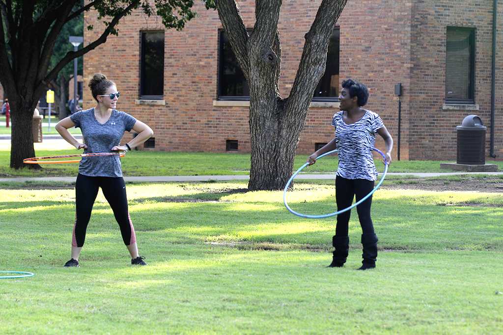 Mikayla Thompson, nursing freshman, and Candace Bledsoe, nursing freshman, hoolahoop on the quad in a attempt to take a break from studying on Oct 18, 2017 for the field day competitions. Photo by Sara Keeling