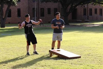 Steven Ehlert, criminal justice junior, Johnny Dang, pre med sophomore, both anticipate and egg on their opponents in a game of cornhole at the quad on Oct 18, 2017. Photo by Sara Keeling