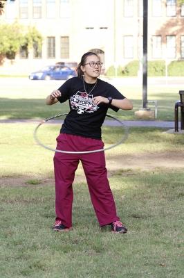 Dalena Pham, radiology junior, hoolahoops on the quad hoping to have fun and relieve some stress at the homecoming field day competitions on Oct 18, 2017. Photo by Sara Keeling
