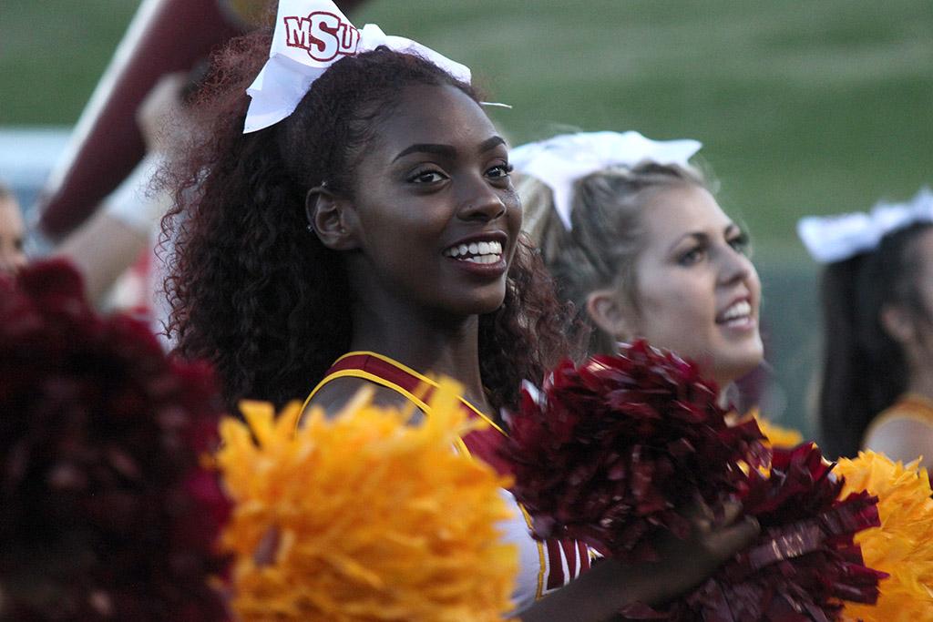 Cheerleading Captain Markiela Benoit, dental hygiene senior, cheers for MSU on the sidelines at Memorial Stadium during the Homecoming Game against West Texas A&M on Saturday, Oct. 21, 2017. Photo by Rachel Johnson