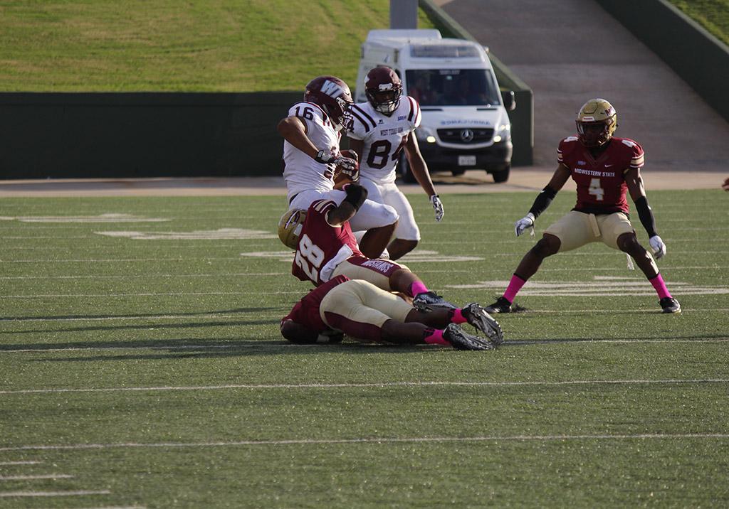 Jordan Meyers, sports and lesiure studies senior, takes down his oppenant in the game against West Texas A&M. Saturday, Oct. 21, 2017. Photo by Sara Keeling