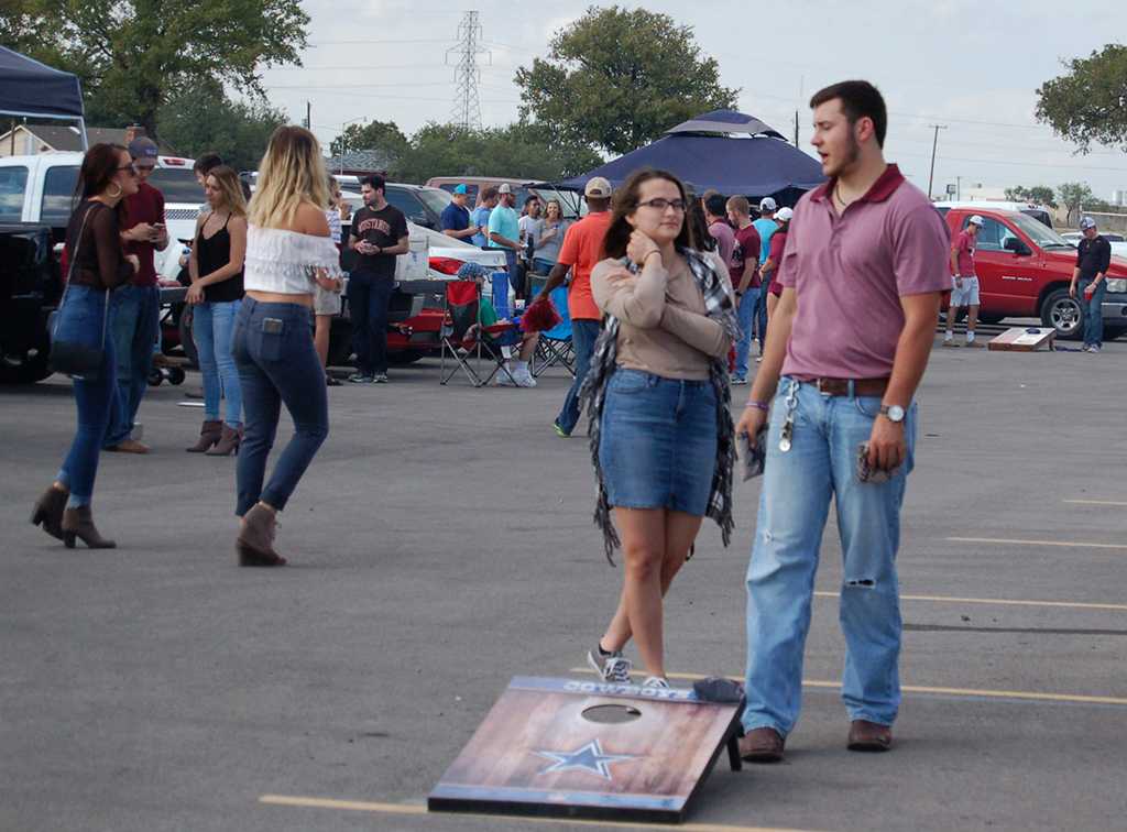 Madelyn Williams, undecided freshman, Christopher Balderas, pre-med freshman, play corn hole at homecoming tailgate on Saturday, Oct. 17, 2017. Photo by Shea James