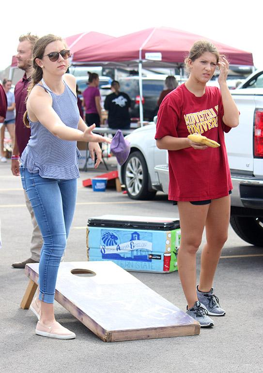 Abigail Helms, nursing junior, and Abigail Gentry, finance junior, play corn hole at the Tailgate outside of Memorial Stadium for the Homecoming game, Saturday Oct 21, 2017. "It's fun meeting new people and hanging out with everyone in Greek Life," Helms said.Photo by Rachel Johnson
