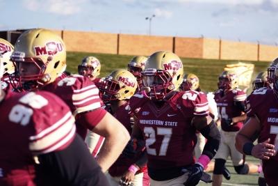 The football team runs onto the field beofre the football game at the Memorial Stadium where the Mustangs won 45-3 on Saturday, Oct. 21, 2017. Photo by Justin Marquart
