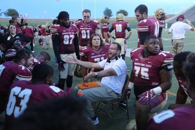 An assistant coach talks with players at the homecoming game against West Texas A&M Oct. 21, 2017. MSU won the game, called with about 5 minutes left on the clock due to weather, 45-3. Photo by Bradley Wilson.