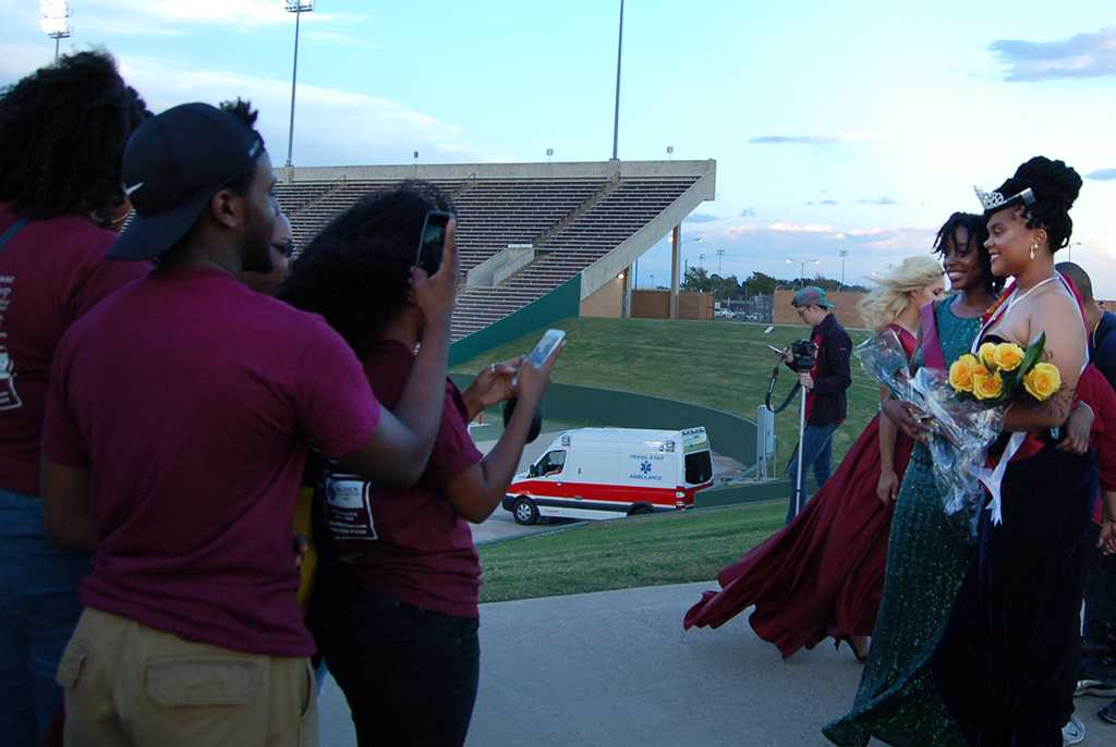 Jaylon Williams, sociology senior, takes pictures with her friends and family before after being announced Homecoming Queen on Oct. 17, 2017. photo by Shea James