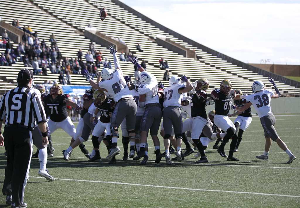 After a successful touchdown by wide reciever and criminal justice sophomore Xavier Land, kicker/punter and sports and leisure sophomore Jaron Imbriani kicks a goal against University of Sioux Falls in the first game of the NCAA Divison II playoffs. Nov 18. Photo by Bridget Reilly