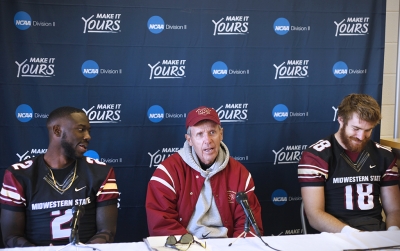 Safety and criminal justice junior Sir'Vell Ford, head coach Bill Maskill, and quarterback accounting junior Layton Rabb, at the press conference after the first game of the NCAA Division II playoff, where they beat University of Sioux Falls 24-20. Nov 18. Photo by Bridget Reilly
