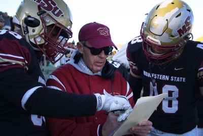 Head Football Coach Bill Maskill discusses plays with players Travon Ransom, criminal justice sophomore, and Alec Divalerio, exercise physiology junior, during the last 5 minutes of the fourth quarter during the Round One NCAA II Playoff game against University of Sioux Falls at Memorial Stadium, Saturday Nov. 18, 2017. Photo by Rachel Johnson