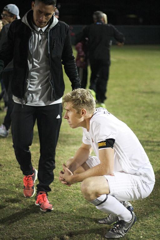 Pierre Bocquet, business senior, squats silently after MSU lost to Cal Poly Pomona in the NCAA II Championship Playoff game during the penality kick shoot out at Stang Park Saturday, Nov. 18, 2017. Photo by Rachel Johnson