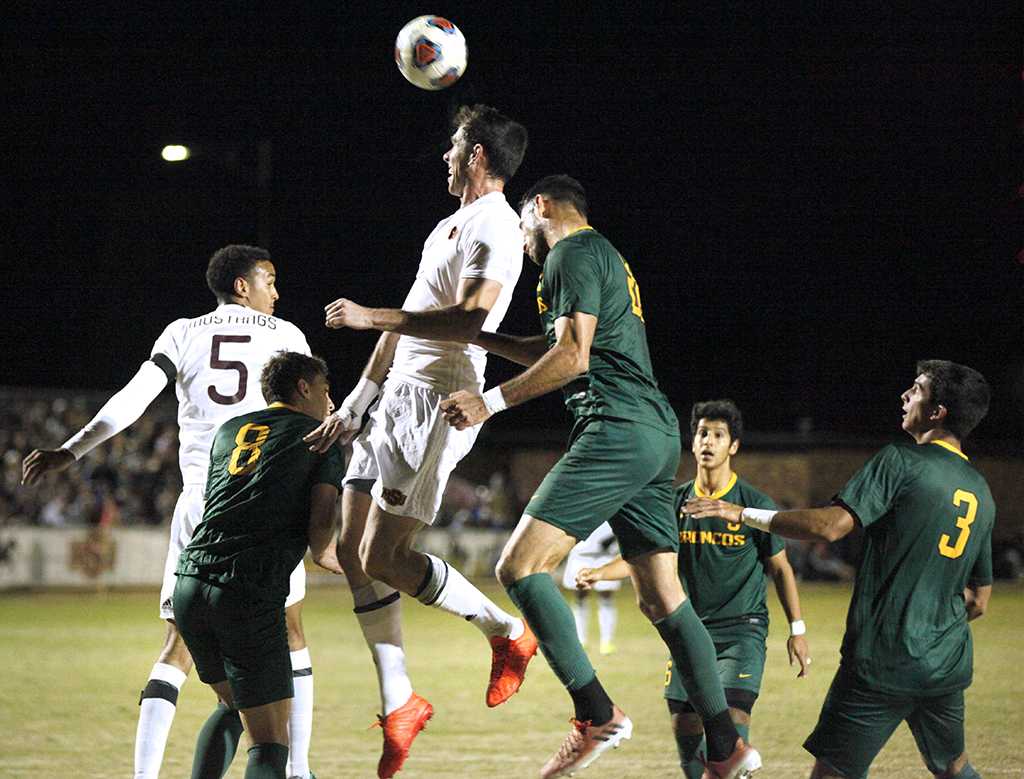 Forward and psychology senior Scott Doney defends a corner kick by Cal Poly Pomona with a header to the center field. Nov 18. Photo by Bridget Reilly