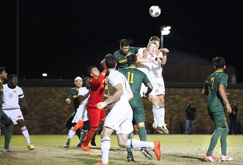 Midfielder and business senior Pierre Bocquet jumps to deflect a corner kick by Cal Poly Pomona with midfielder and exercise physiology sophomore Ross Fitzpatrick in the NCAA Division II Championship playoff. Nov 18. Photo by Bridget Reilly