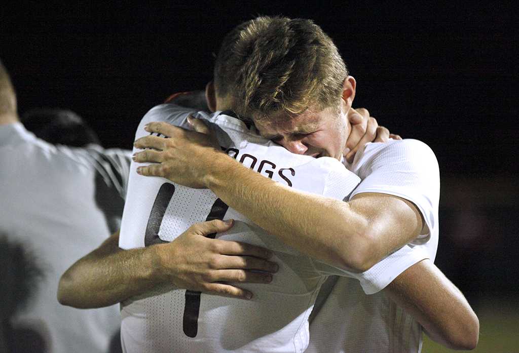 Midfielder and exercise physiology sophomore Ross Fitzpatrick embraces defender and kinesiology junior Patrick Fitzgerald, after six rounds of penalty shootouts, losing 6-5 in the NCAA Division II Championship playoff against Cal Poly Pomona. Nov 18. Photo by Bridget Reilly