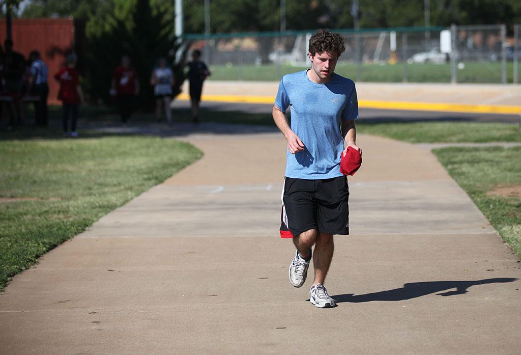 Jacob Warren, economics junior, runs during the Counseling Center's 5K Run for Suicide Prevention Awareness at Sikes Lake, Sept. 13. He finished as the first male runner. Photo by Herbert McCullough