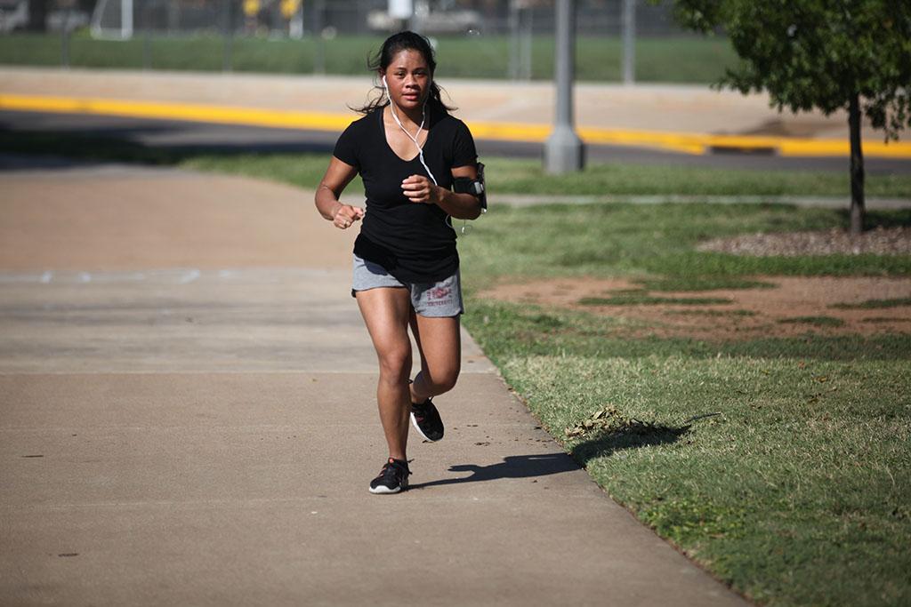 Mallory Evangelista, english junior, runs during the Counseling Center's 5K Run for Suicide Prevention Awareness at Sikes Lake, Sept. 13. Photo by Herbert McCullough