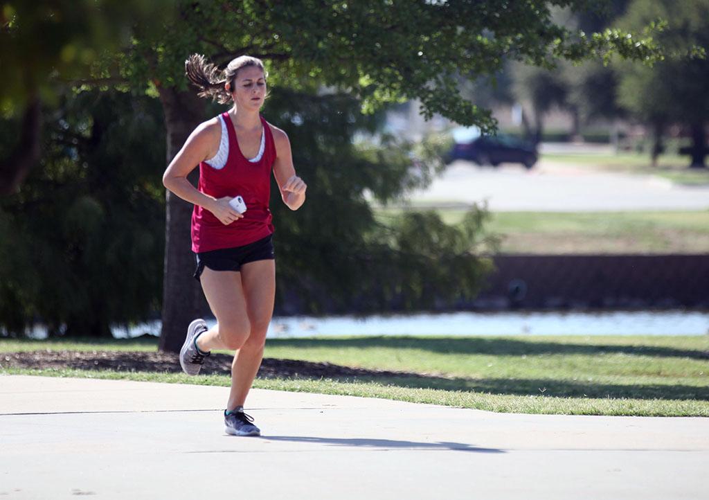 Alexandra Blake, accounting junior, runs during the Counseling Center's 5K Run for Suicide Prevention Awareness at Sikes Lake, Sept. 13. She finishes second. Photo by Herbert McCullough