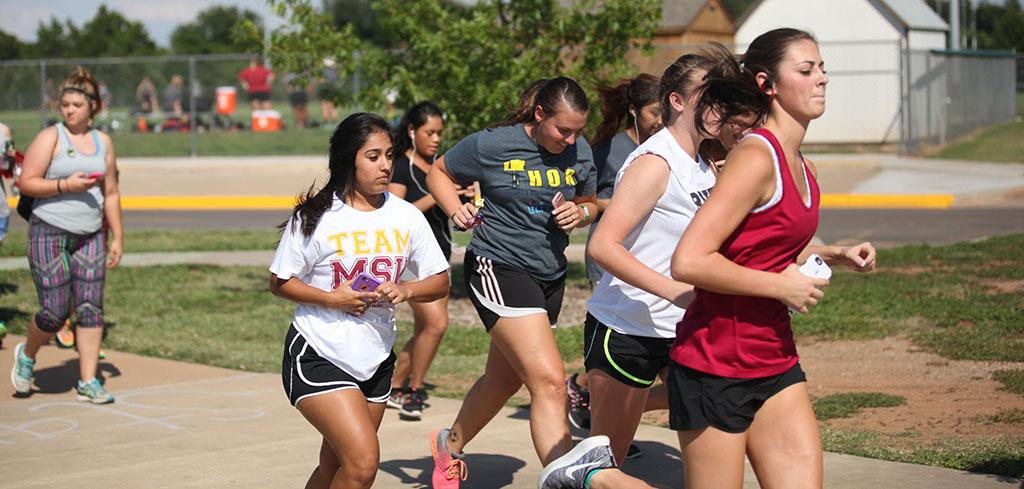 Alexandra Blake, accounting junior, pulls ahead of the start of the Counseling Center's 5K Run for Suicide Prevention Awareness at Sikes Lake, Sept. 13. Photo by Herbert McCullough