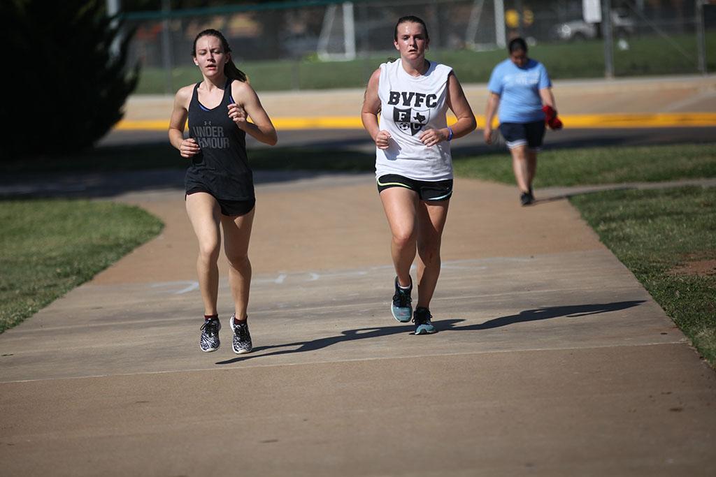 Mackenzie Trammell, business management freshmen, and Rebekah Barrett, Respiratory Care, Freshman run during the Counseling Center's 5K Run for Suicide Prevention Awareness at Sikes Lake, Sept. 13. They both share first place. Photo by Herbert McCullough