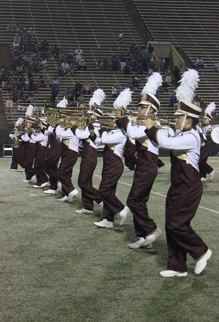Golden Thunder Marching band starts off their halftime show with a preformance of the Alma Mater in their first show of the season at Memorial Stadium, Sept. 5. Photo by Rachel Johnson