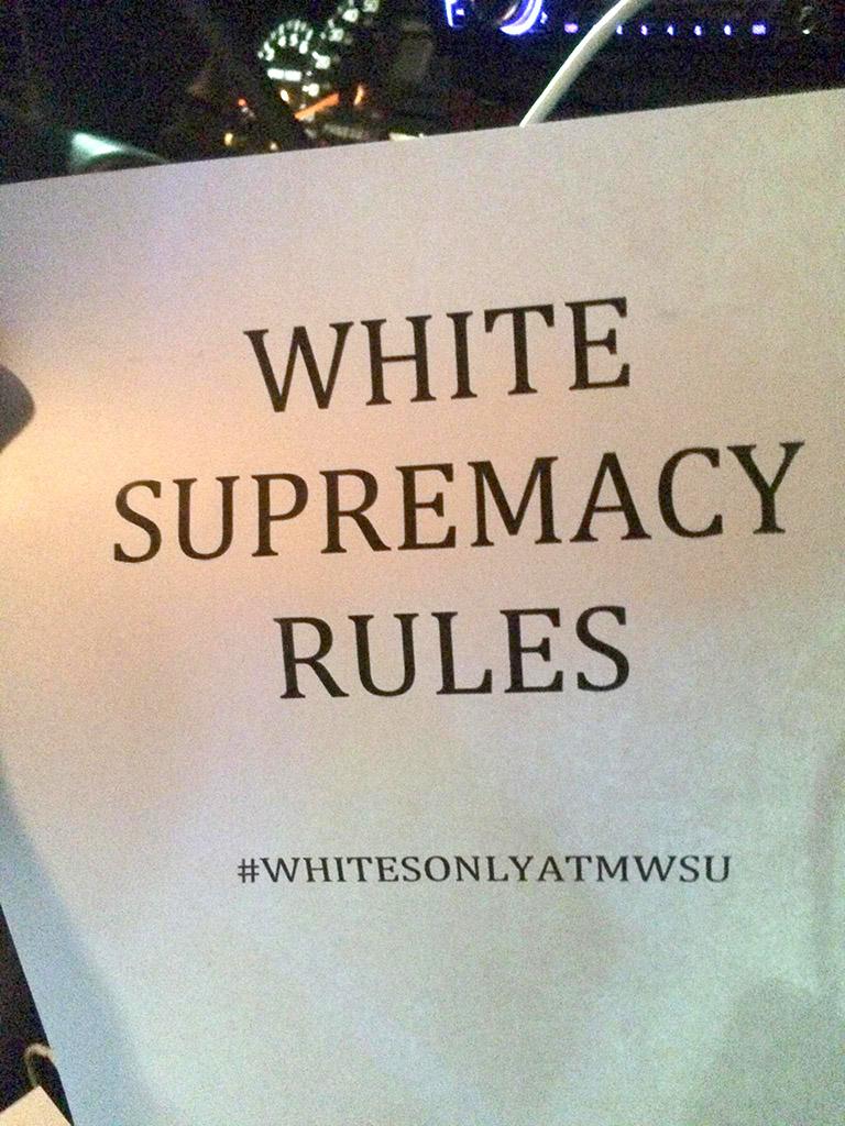 This "White Supremacy Rules" poster was posted on a car on campus along with 3 other posters similar to it with different hashtags. The other three hashtags included: #FUCKCAMPUSCLIMATE, #WHITEPOWER, and #ONOURCAMPUS with the same "White Supremacy Rules" at the top of all of them. Photo by Francisco Martinez